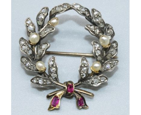Yellow and white metal brooch in the form of a wreath set with diamonds and pearls, with ruby set ribbon, D3.5cm, 6.4g 