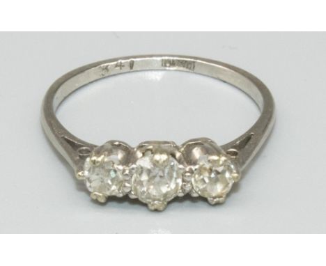 Platinum three stone diamond ring, the three graduated round cut diamonds in claw settings, on tapered shoulders and plain sh