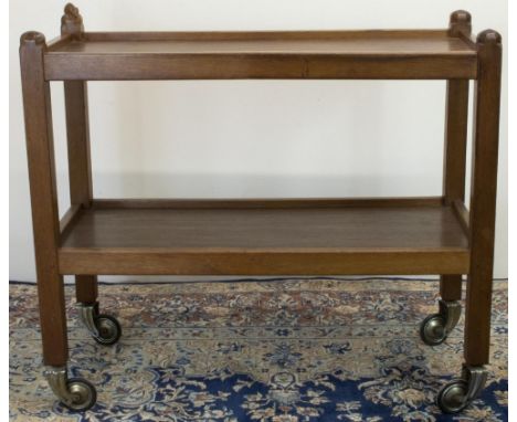 Robert "Mouseman" Thompson of Kilburn - an oak two tier tea trolley, with octagonal faceted finials on square supports and ca