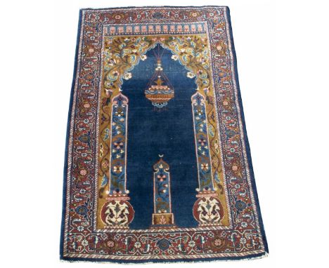 Persian style multicoloured Prayer style rug, blue ground field with lantern enclosed by columns in multi stripe repeating bo