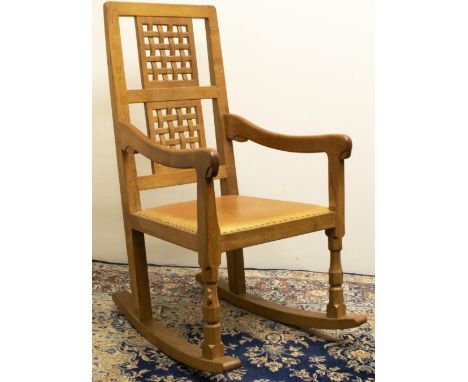 Robert "Mouseman" Thompson of Kilburn - an oak rocking chair with twin lattice panel back and brass nailed leather upholstere