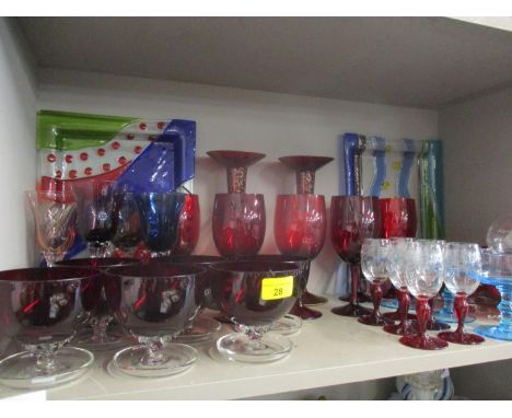 A collection of decorative glass to include ruby red pedestal wine glasses and three art glass rectangular and square formed 