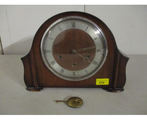 A Smiths early to mid 20th century walnut cased mantel clock with Westminster chimes, the movement striking on a gong, with p