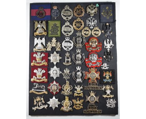 Mounted display of approximately 46 British Army metal and anodised Cavalry Regiment badges including 16th Lancers, 22nd Drag