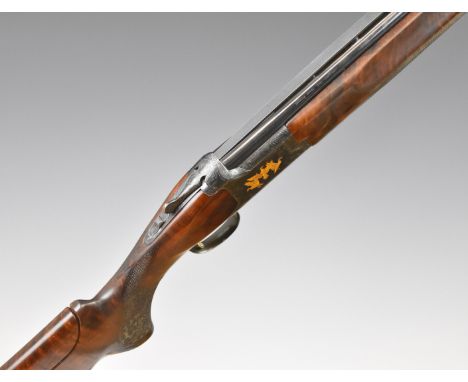 Browning Citori 12 bore over and under shotgun with gold engraving of birds and dogs surrounded by further scrolling engravin
