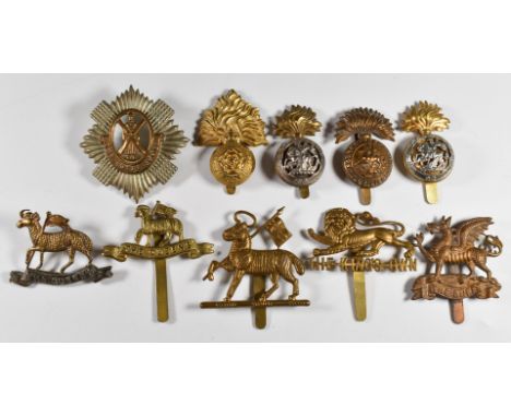 Ten British Army Infantry metal cap badges including the Royal Scots, Queens, The Buffs, King's Own and Northumberland Fusili