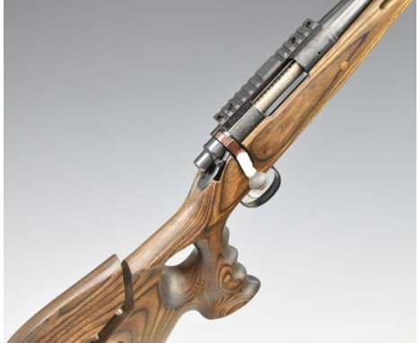 Remington Model 700 .17 REM bolt-action rifle with shaped thumb-hole grip and adjustable comb to the laminate show wood stock