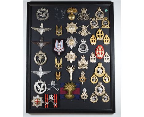 Mounted display of approximately 40 British Army badges including Special Air Service, Parachute Regiment, Guards and Infantr