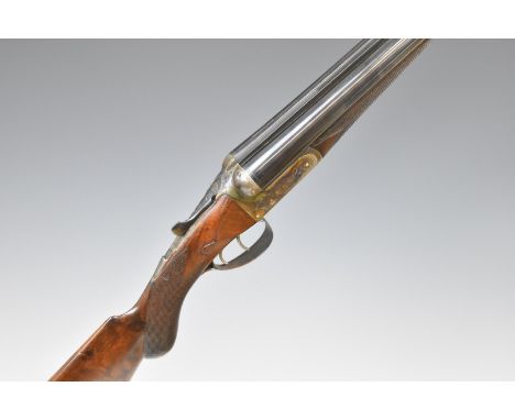 Frederick T Baker 12 bore side by side shotgun with engraved lock, trigger guard, thumb lever, fences and underside, chequere