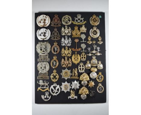 Mounted display of approximately 50 mostly British Army metal and staybrite badges including London Regiment, Light Infantry,