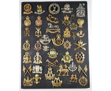 Mounted display of approximately 40 British Army metal badges including Royal Gloucestershire Hussars, Westminster Dragoons, 