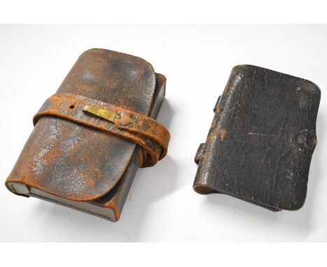 Leather ammunition pouches, one with internal tin plate compartment retaining its pull/extraction ring and separate twin cap 