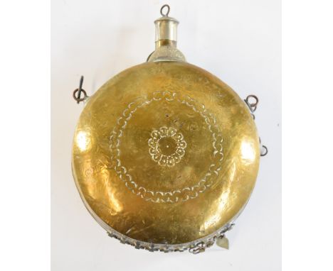 Eastern copper and silver inlaid brass powder flask with belt loops, 14cm in diameter.&nbsp;