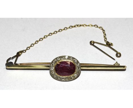 A ruby and diamond cluster&nbsp;brooch set oval ruby, approximately 9 x 7.5mm, within a border of eighteen 8/8-cut diamond po