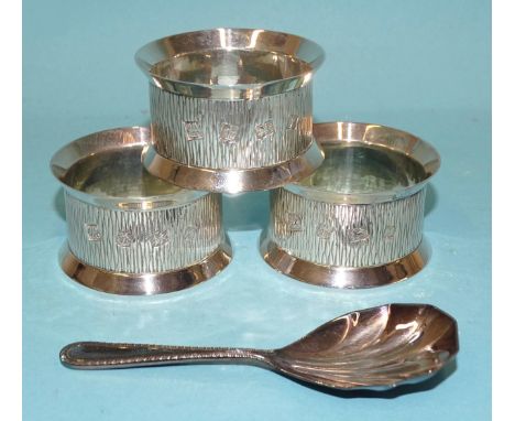 Three silver napkin rings with textured decoration, maker PH Vogel &amp; Co, Birmingham 1973, all boxed and a modern silver c