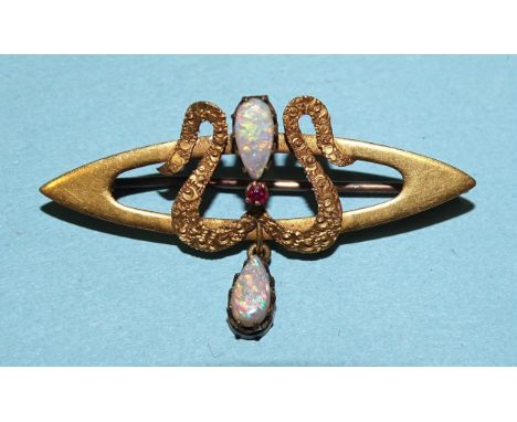 An Art Nouveau brooch of marquise form, overlaid with a textured 'W', form-set within an opal and ruby, with opal drop below,