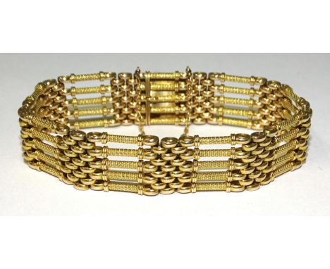 A Victorian 15ct gold gate-link bracelet of textured and smooth links, with concealed clasp, 21cm long, 50.8g.