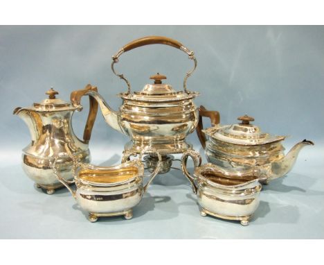 A five-piece silver tea service of plain rectangular form, on bun feet, including: spirit kettle, teapot, hot water jug, suga