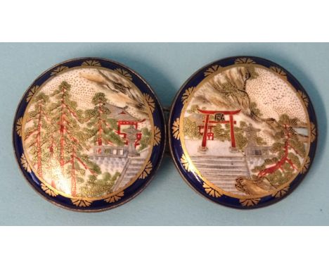 A Japanese Satsuma porcelain two-piece buckle, each circular plaque depicting buildings, torii gate and trees, each 4.3cm, (s