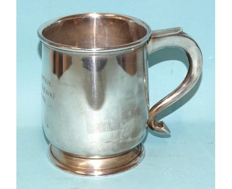 A silver tankard of plain form with inscription, Birmingham 1936, 11cm high, 326.4g, ___10.5oz, (one dent to side).