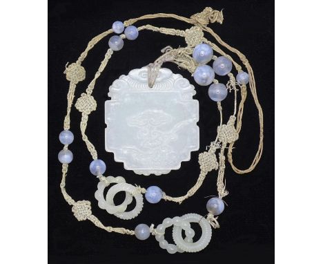 A Chinese celadon jade and blue agate necklace, the pendant of shaped oval form, carved in low relief&nbsp; with lingzhi on o