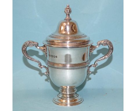 A George VI small silver trophy cup and cover with ribbed decoration and scroll handles, maker Daniel George Collins, London 