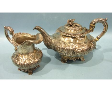 A Victorian silver teapot of compressed form, with overall embossed floral decoration, the hinged lid with flower finial, the