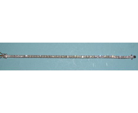 A good-quality diamond tennis bracelet claw-set fifty-two well-matched brilliant-cut diamonds, in 18k white gold, with concea