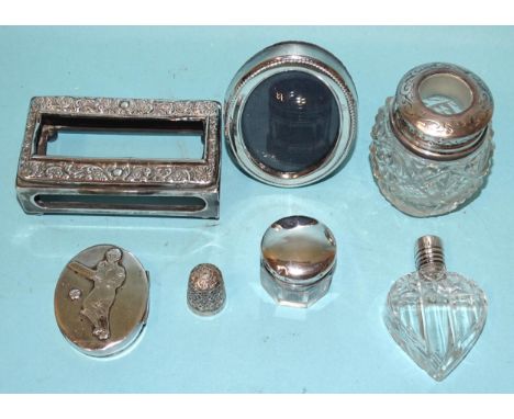 An embossed silver matchbox holder, Chester 1905, a cut-glass heart-shaped scent bottle with stopper and silver lid and other