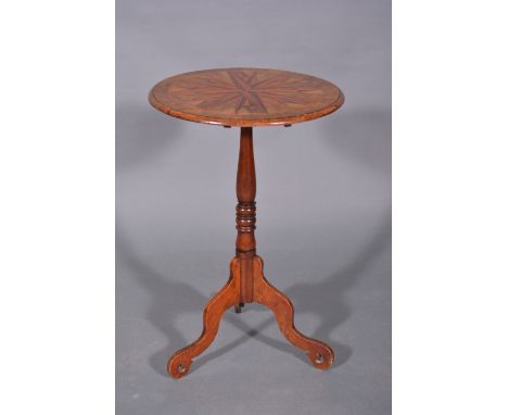 A Victorian walnut and parquetry pedestal table, circular tilt-top with a star motif, ringed column on tripod scrolled legs, 