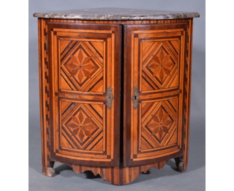 A Dutch mahogany and parquetry encoignure, early 19th Century, quadrant shape marble top, two bow front doors with geometric 