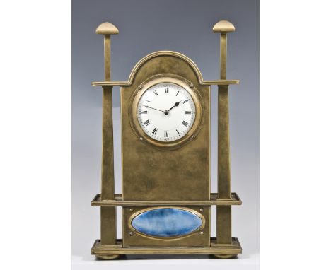 An Arts and Crafts mantel clock, circa 1900, in the style of George Walton, the brass case with domed top above a rectangular