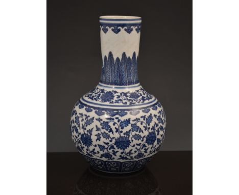 A Chinese blue and white bottle vase, bearing six character seal mark, decorated with stylised flowers, floral bands and stif