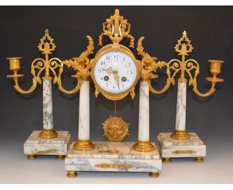 A French Empire style three piece alabaster and gilt metal clock garniture, the clock in a drum shape case, mounted with a li