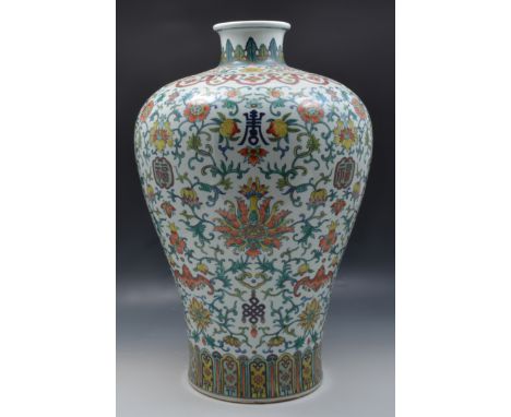 A Chinese polychrome Meiping vase, bearing Yongzheng six character seal mark, decorated with stylised flowers, fruit and symb