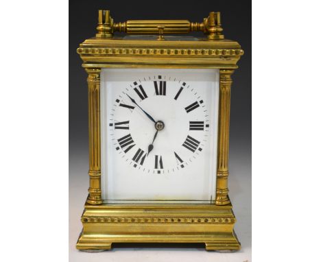 A French repeating brass cased corniche carriage clock, fluted columns, reeded handle, white enamel dial, platform escapement