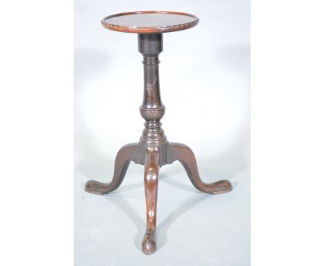 A George II style walnut kettle stand, circular top with a moulded edge, baluster column on tripod legs, diameter 31cm, heigh