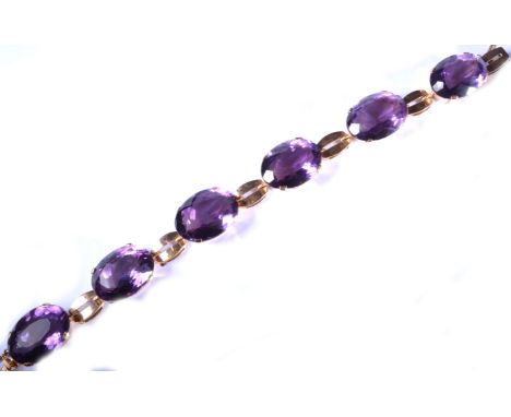 A six stone amethyst bracelet, yellow metal settings, faceted stones each approximately 12mm x 15mm, individually in four cla