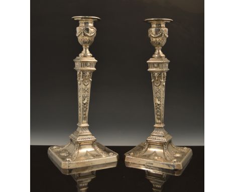 A pair of silver candlesticks, in the style of Robert Adam, by William Hutton & Sons Ltd, Sheffield 1916, urn sconces, decora