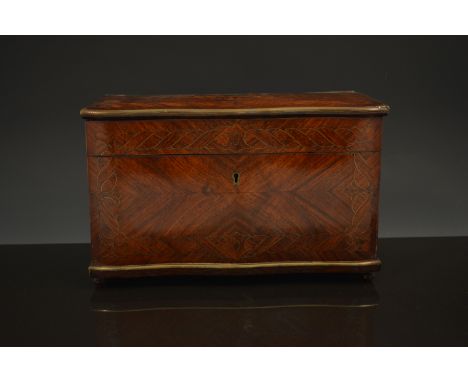 A French rosewood and kingwood serpentine shape caddy, circa 1870, slightly domed quartered top with a blank brass cartouche,