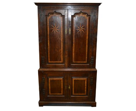 A reproduction oak cupboard, in the mid 18th Century style, moulded cornice, arched top fielded panelled doors, with burr woo