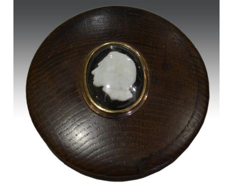 Admiral Lord Nelson - The Battle of Trafalgar: a circular oak and rose metal snuff box, the lid with a cameo of Lord Nelson, 