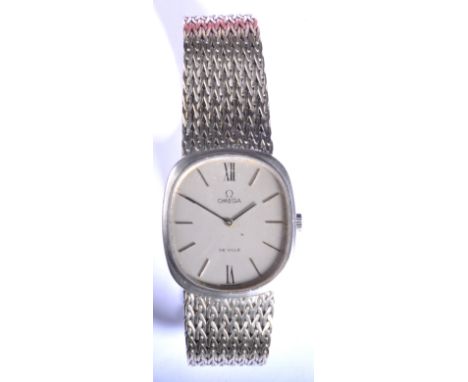 A gentleman's 18ct white gold Omega De Ville wristwatch, shaped rectangular and silvered baton dial, on an integral flexible 