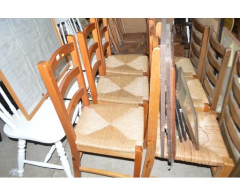 A set of six pine ladder back and rush seated chairs