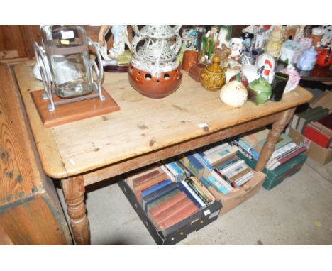 A stripped pine kitchen table fitted single end drawer