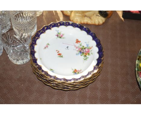 A set of five Royal Worcester shallow dishes, having lobed borders and painted floral spray decoration with rich blue and gil