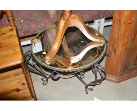 A wrought iron and mirrored glass topped circular table in the French style 