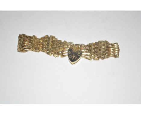 A yellow metal gate link bracelet with padlock clasp
