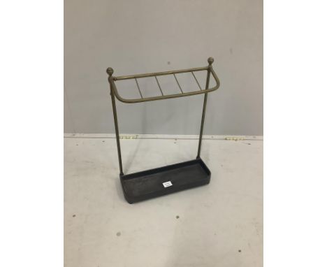 An Edwardian brass and cast iron five division stick stand, height 57cm together with four walking sticks