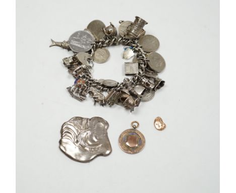 A silver charm bracelet, hung with assorted mainly white metal charms including tankard and Knight's helmet, two 'melted' ing